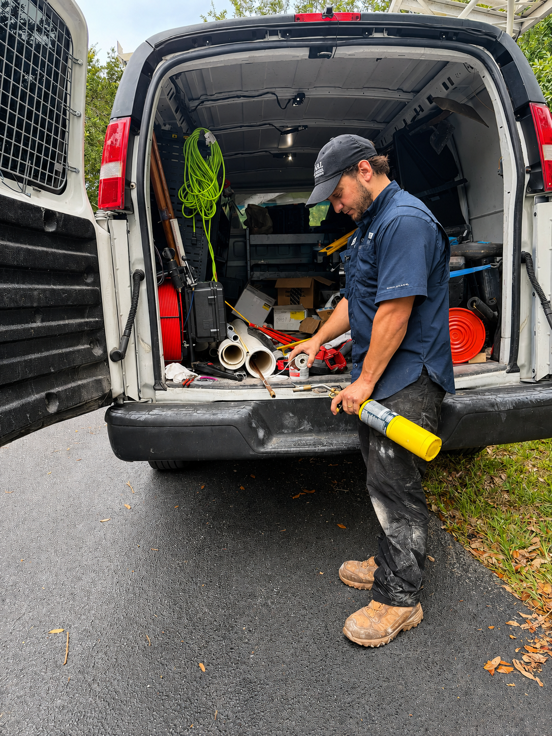 A&L Premier Plumbing technician preparing equipment from the service van in Miramar, Florida