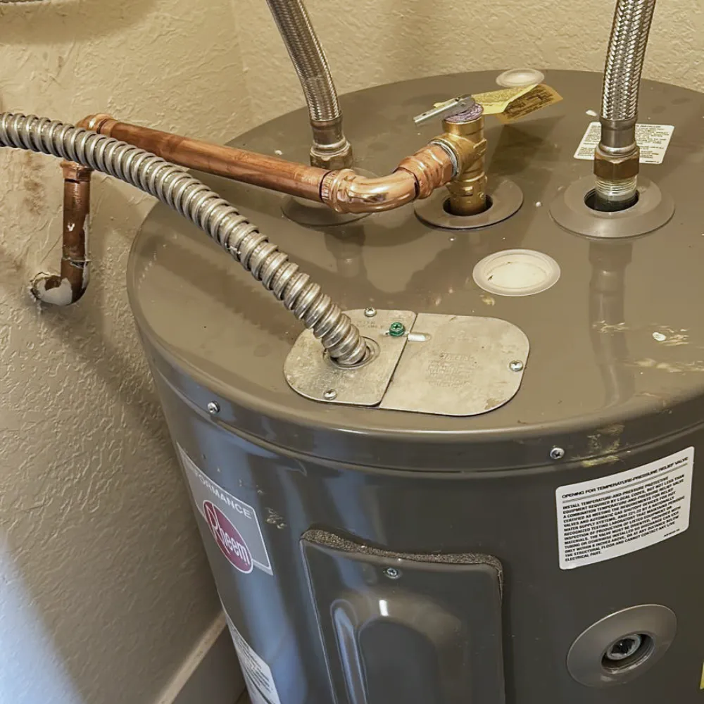 New Rheem electric water heater installed by a licensed plumber in a Miramar, FL home