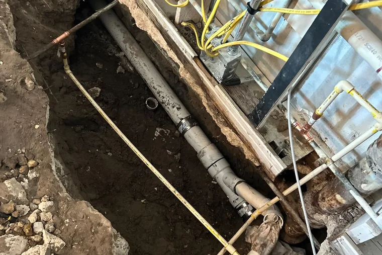 New PVC drain line installed in an open slab trench in Miramar